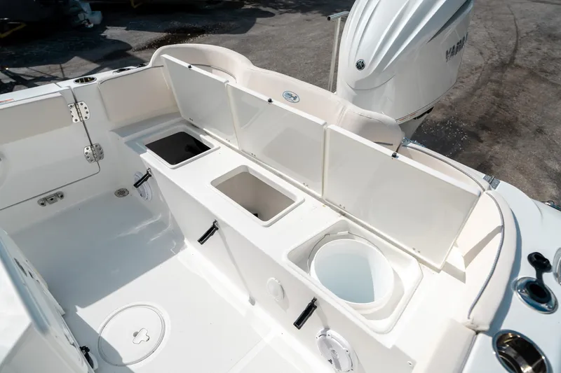 Slide: The Image of 2025 Sea Hunt Ultra 239 SE boat interior with storage compartments and engine. - 15