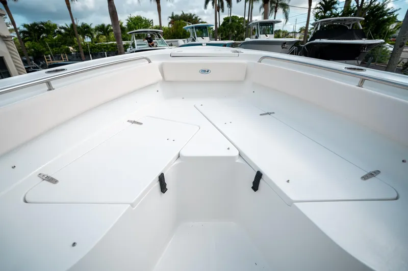 Slide: The Image of 2025 Sea Hunt Ultra 239 SE boat interior with spacious seating and storage compartments. - 41