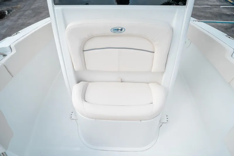 Slide: The Image of 2025 Sea Hunt Ultra 239 SE boat seating, white cushioned bench, sleek design. - 45