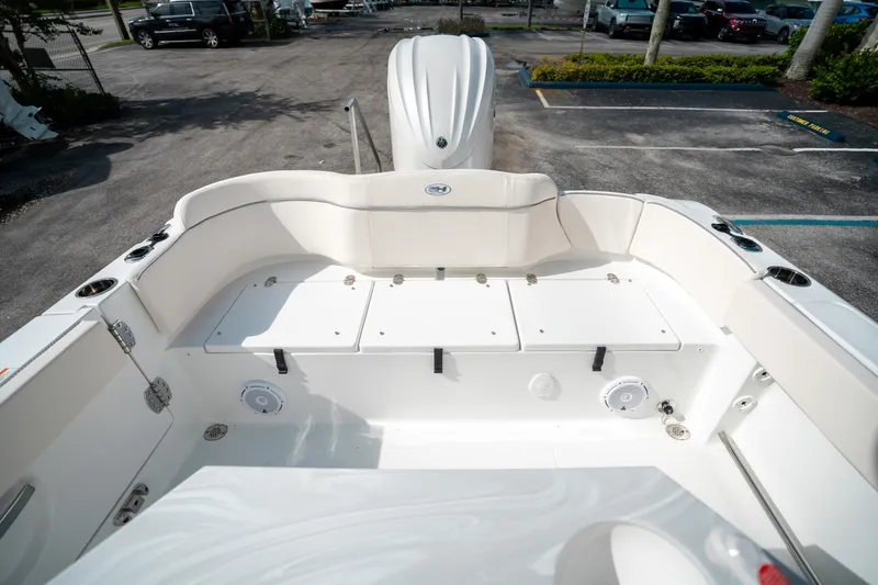 Slide: The Image of 2025 Sea Hunt Ultra 239 SE boat interior with white seating and storage compartments. - 13