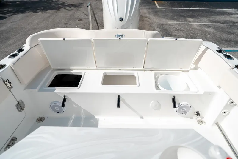 Slide: The Image of 2025 Sea Hunt Ultra 239 SE boat interior with storage compartments and speakers. - 14