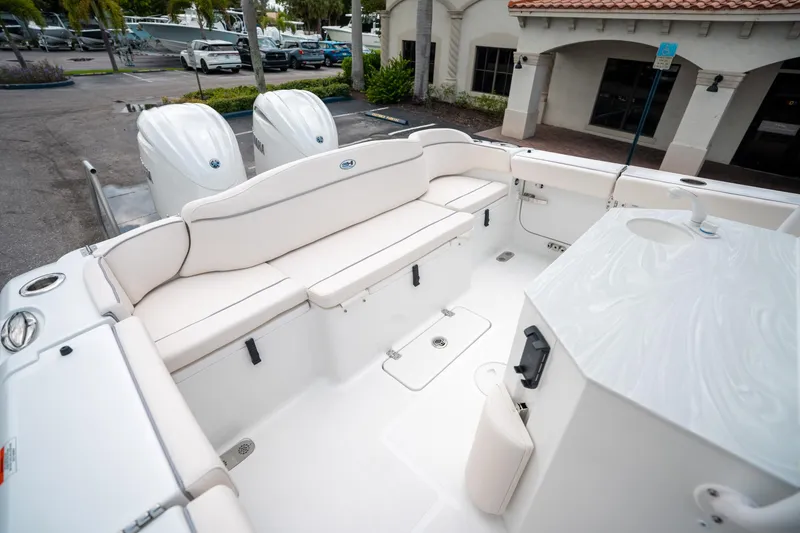 Slide: The Image of 2025 Sea Hunt Ultra 275 SE boat interior with white seating and dual engines. - 12