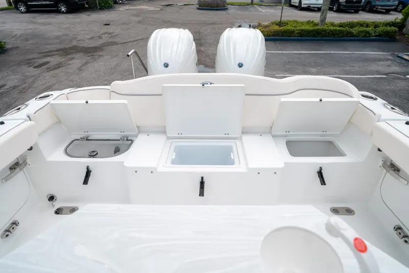 Slide: The Image of 2025 Sea Hunt Ultra 275 SE boat deck with storage compartments and twin engines. - 14