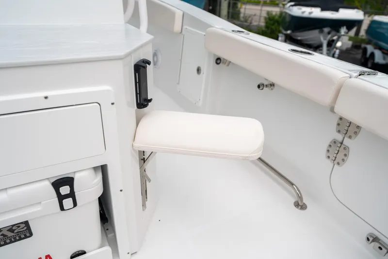 Slide: The Image of 2025 Sea Hunt Ultra 275 SE boat interior with foldable seat and storage compartment. - 18