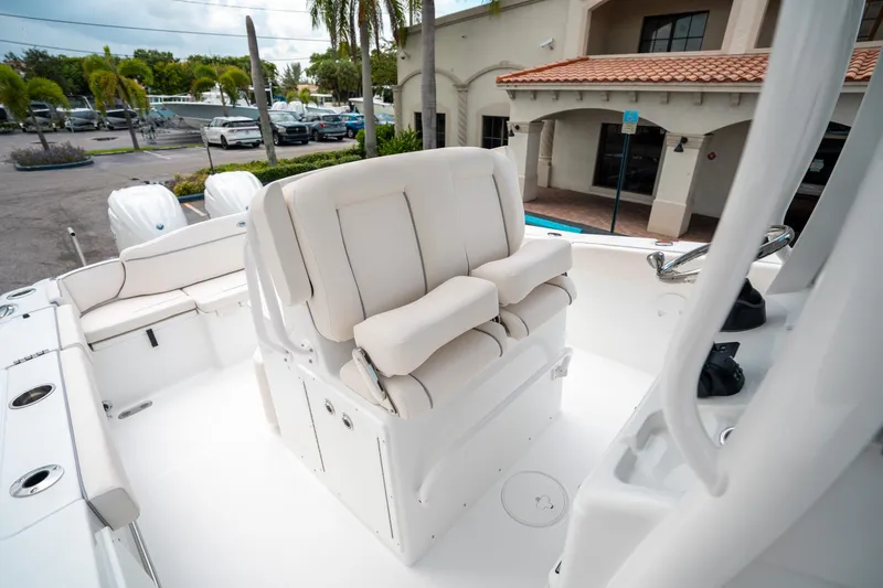 Slide: The Image of 2025 Sea Hunt Ultra 275 SE boat interior with plush seating and dual engines. - 31