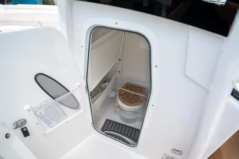 Slide: The Image of Interior view of 2025 Sea Hunt Ultra 275 SE boat's compact bathroom. - 34
