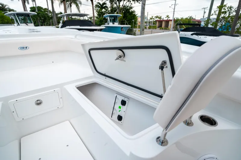 Slide: The Image of 2025 Sea Hunt Ultra 275 SE boat storage compartment open, showcasing interior space. - 46