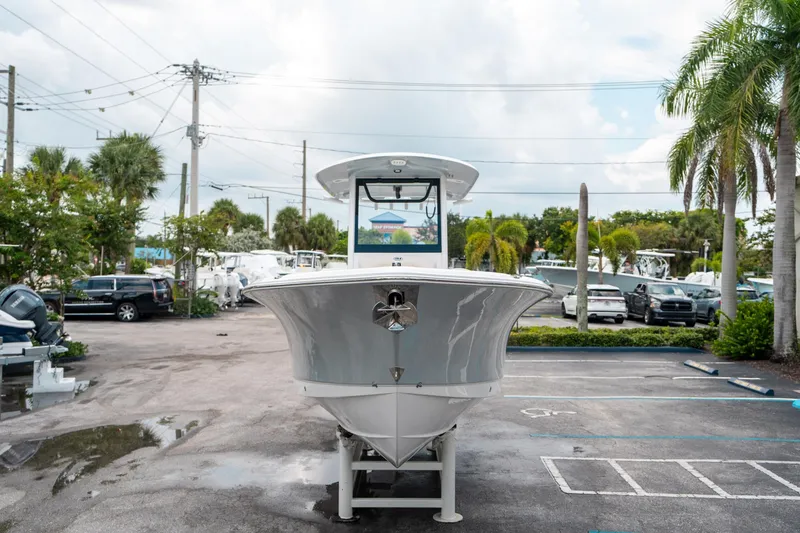 Slide: The Image of 2025 Sea Hunt Ultra 275 SE boat displayed in a parking lot with palm trees. - 7