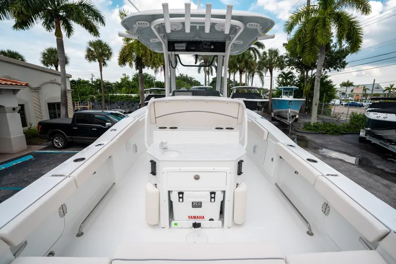 Slide: The Image of 2025 Sea Hunt Ultra 275 SE boat, spacious deck, palm trees in background. - 9