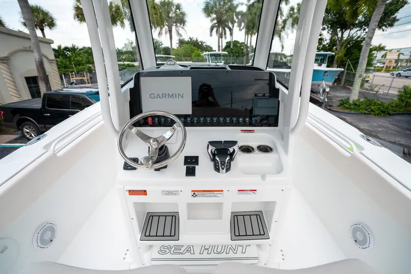 Slide: The Image of 2025 Sea Hunt Ultra 275 SE boat dashboard with Garmin navigation system and steering wheel. - 27