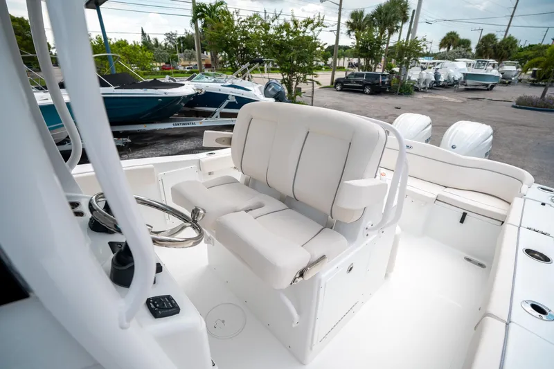 Slide: The Image of 2025 Sea Hunt Ultra 275 SE boat interior with white seating and steering wheel. - 33