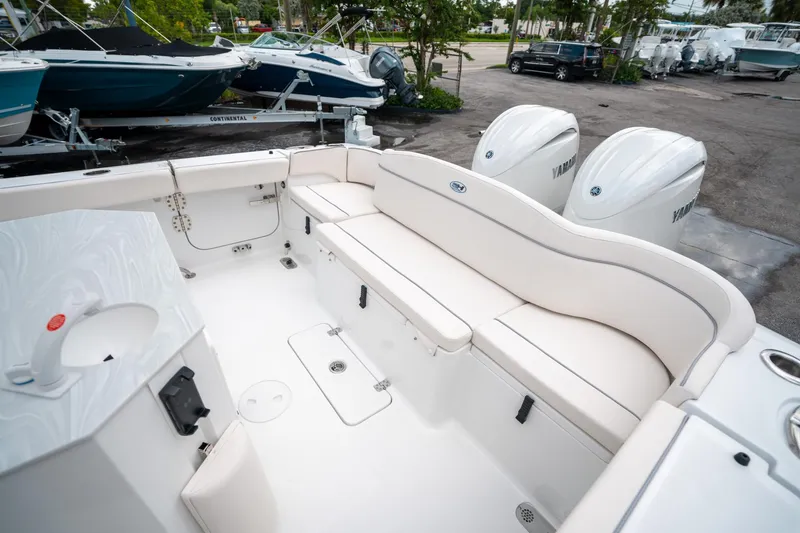 Slide: The Image of 2025 Sea Hunt Ultra 275 SE boat interior with seating and dual Yamaha engines. - 11