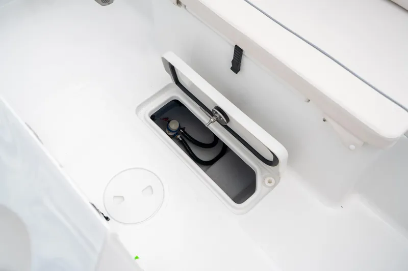 Slide: The Image of 2025 Sea Hunt Ultra 275 SE boat storage compartment with open hatch. - 15