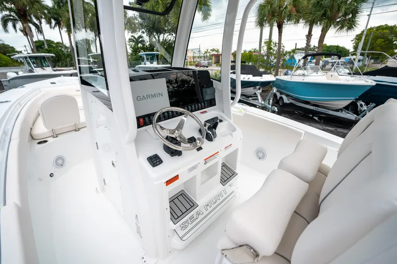 Slide: The Image of 2025 Sea Hunt Ultra 275 SE boat interior with Garmin navigation system and plush seating. - 29