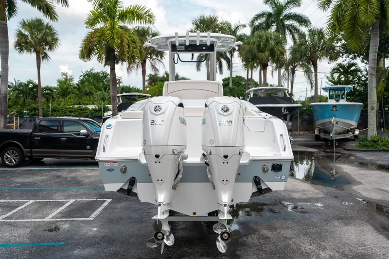 Slide: The Image of 2025 Sea Hunt Ultra 275 SE boat with dual Yamaha engines, parked outdoors. - 3