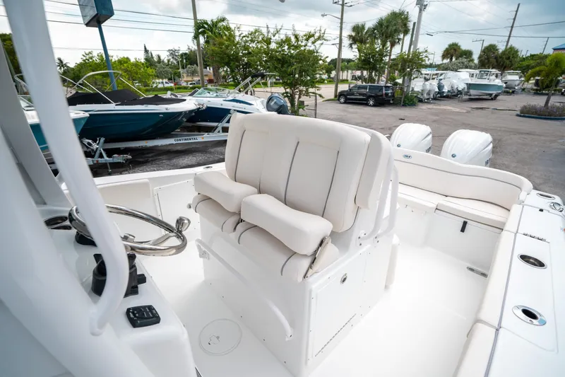 Slide: The Image of 2025 Sea Hunt Ultra 275 SE boat interior with plush seating and dual engines. - 30