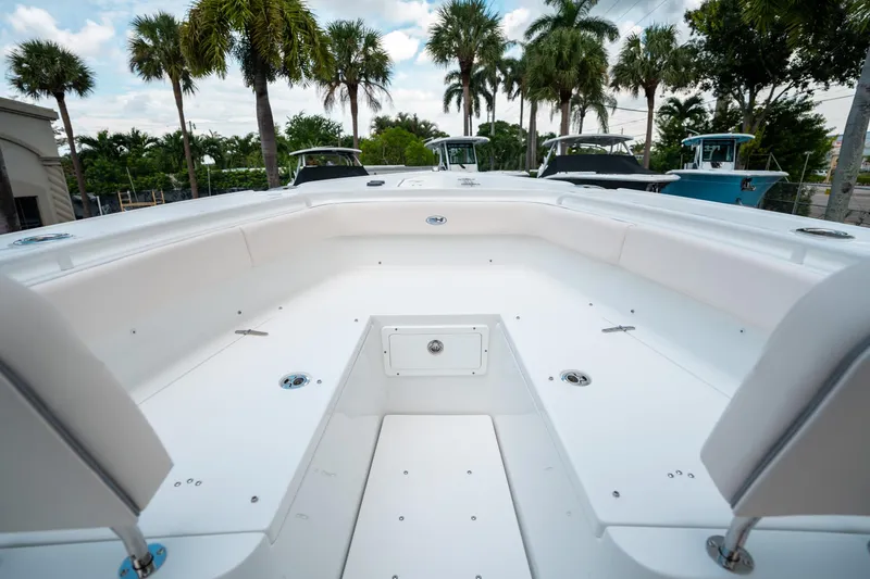 Slide: The Image of 2025 Sea Hunt Ultra 275 SE boat interior with spacious seating and palm trees in the background. - 43