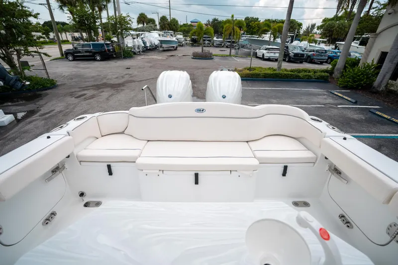 Slide: The Image of 2025 Sea Hunt Ultra 275 SE boat interior with white seating and dual engines. - 10