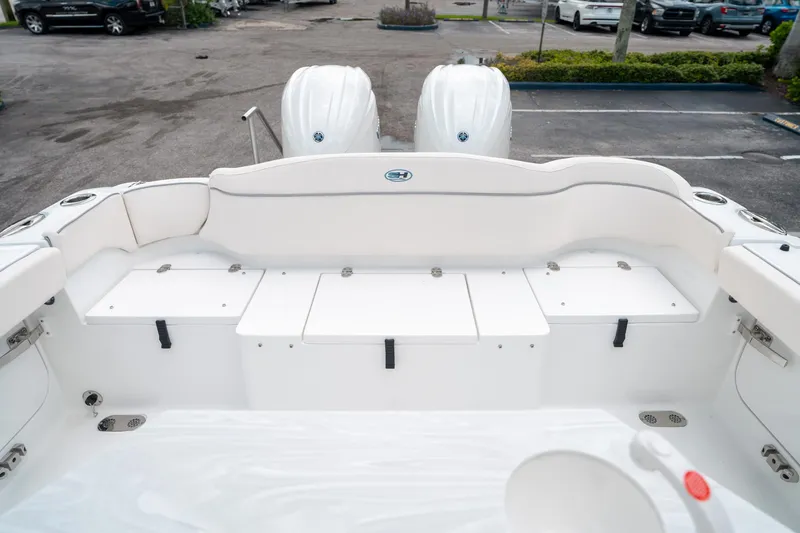 Slide: The Image of Sea Hunt Ultra 275 SE 2025 boat interior with dual engines, white seating, and storage compartments. - 13