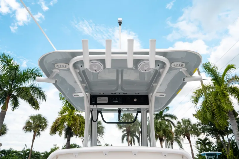 Slide: The Image of 2025 Sea Hunt Ultra 275 SE boat top view with palm trees and blue sky. - 21