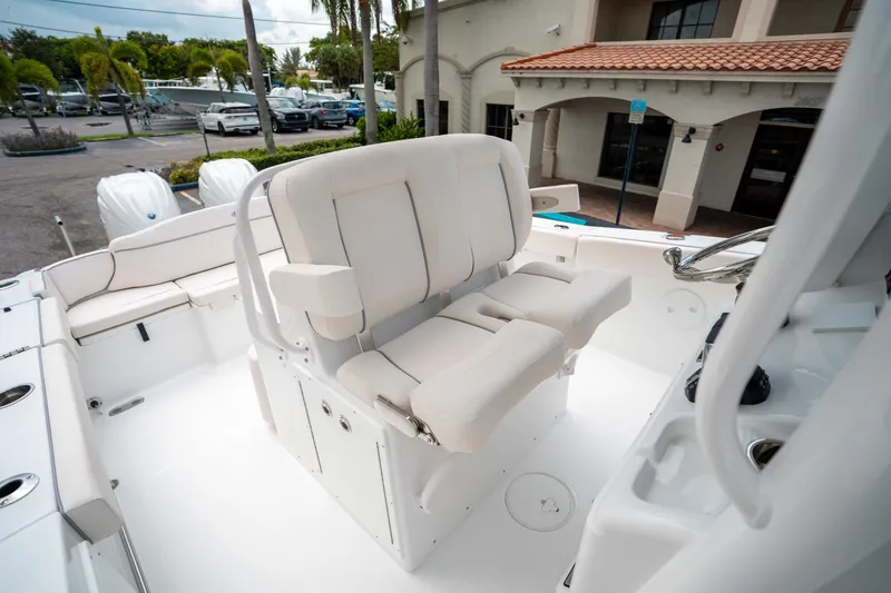 Slide: The Image of 2025 Sea Hunt Ultra 275 SE boat interior with white seating and helm. - 32