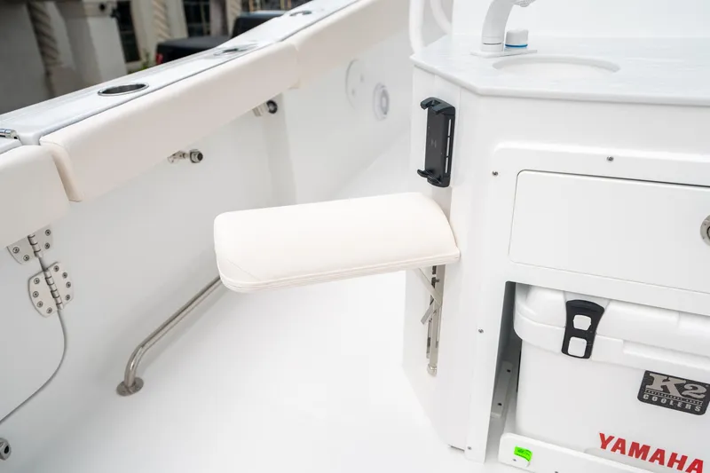 Slide: The Image of 2025 Sea Hunt Ultra 275 SE boat interior with white seating and storage area. - 17