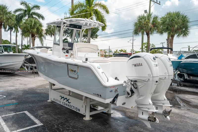 Slide: The Image of 2025 Sea Hunt Ultra 275 SE boat with twin Yamaha engines, displayed outdoors. - 4