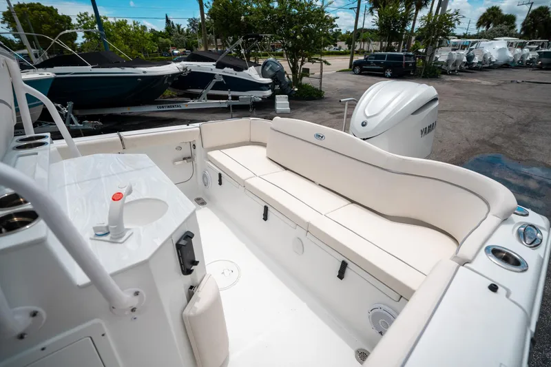 Slide: The Image of 2025 Sea Hunt Ultra 255 SE boat interior with seating and Yamaha engine. - 11