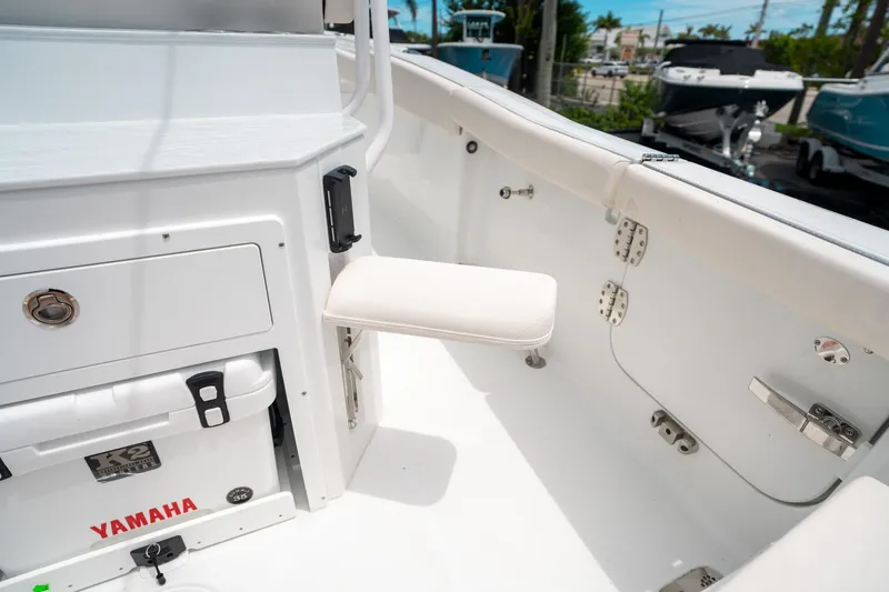 Slide: The Image of 2025 Sea Hunt Ultra 255 SE boat interior with Yamaha cooler and foldable seat. - 17