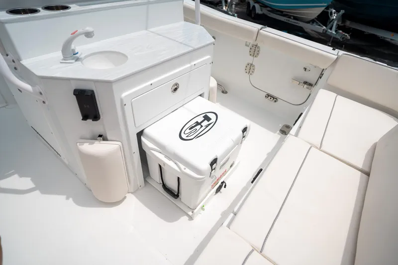 Slide: The Image of 2025 Sea Hunt Ultra 255 SE boat interior with seating and storage area. - 19