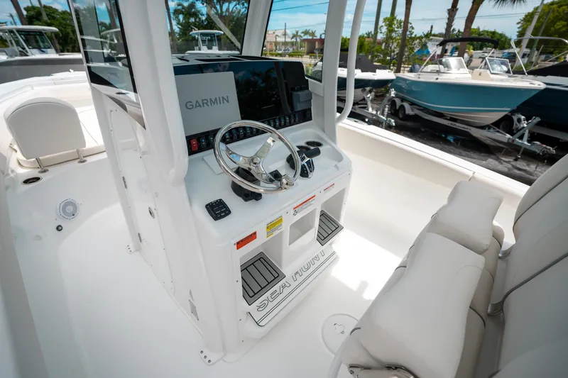 Slide: The Image of 2025 Sea Hunt Ultra 255 SE boat cockpit with Garmin navigation system. - 26