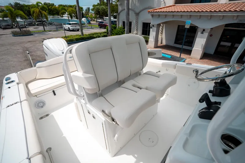 Slide: The Image of 2025 Sea Hunt Ultra 255 SE boat interior with white seating and steering wheel. - 30