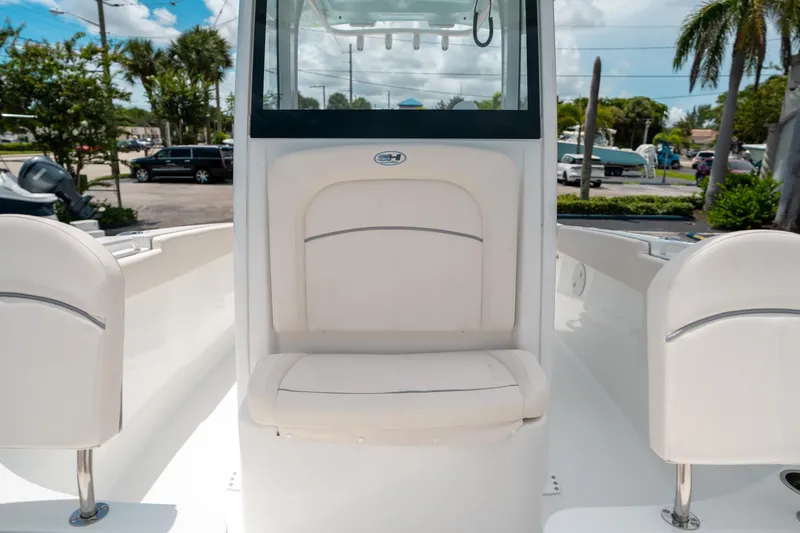 Slide: The Image of 2025 Sea Hunt Ultra 255 SE boat interior with white seating and console. - 38