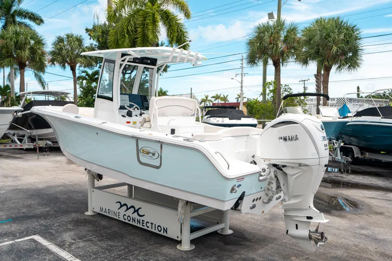 Slide: The Image of 2025 Sea Hunt Ultra 255 SE boat with Yamaha engine, displayed outdoors at Marine Connection. - 4