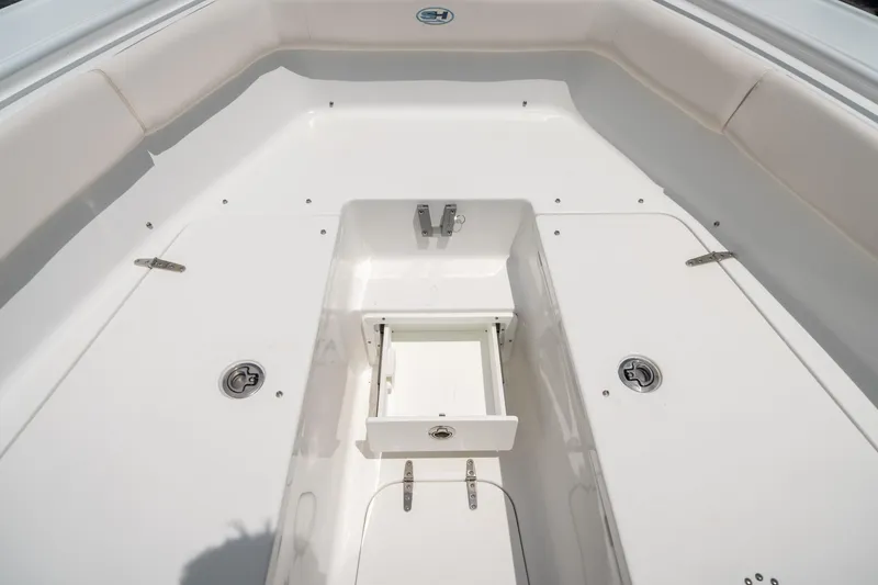Slide: The Image of 2025 Sea Hunt Ultra 255 SE boat interior with storage compartment open. - 45