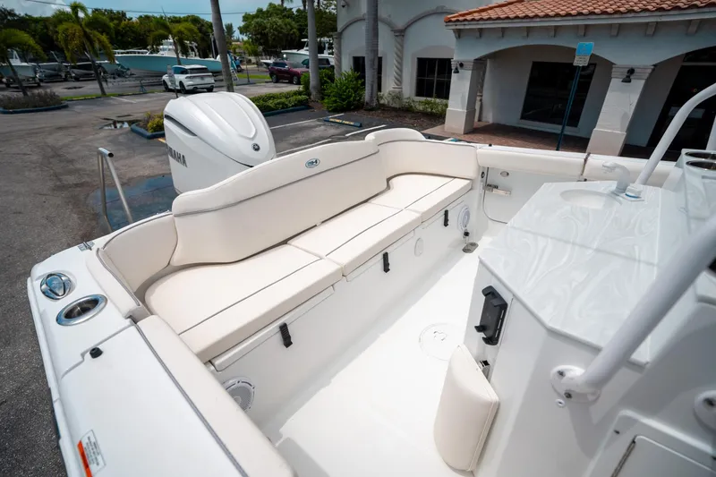 Slide: The Image of 2025 Sea Hunt Ultra 255 SE boat interior with white seating and Yamaha engine. - 12