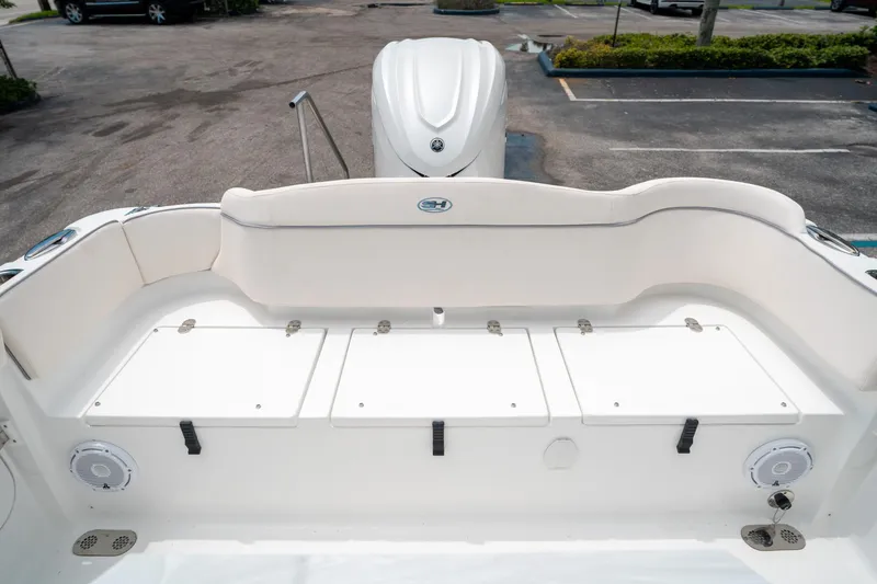 Slide: The Image of 2025 Sea Hunt Ultra 255 SE boat interior with seating and storage compartments. - 13