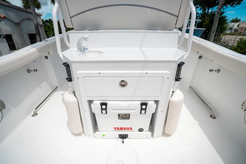 Slide: The Image of 2025 Sea Hunt Ultra 255 SE boat interior with sink and storage compartment. - 15