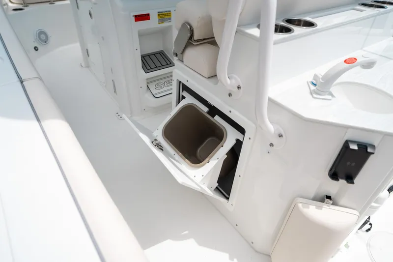 Slide: The Image of 2025 Sea Hunt Ultra 255 SE boat interior with storage compartment open. - 21