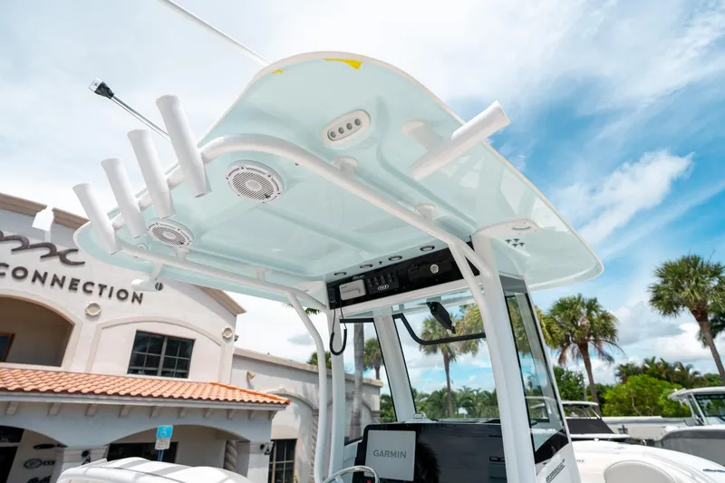 Slide: The Image of 2025 Sea Hunt Ultra 255 SE boat with advanced electronics and rod holders, under a clear blue sky. - 23