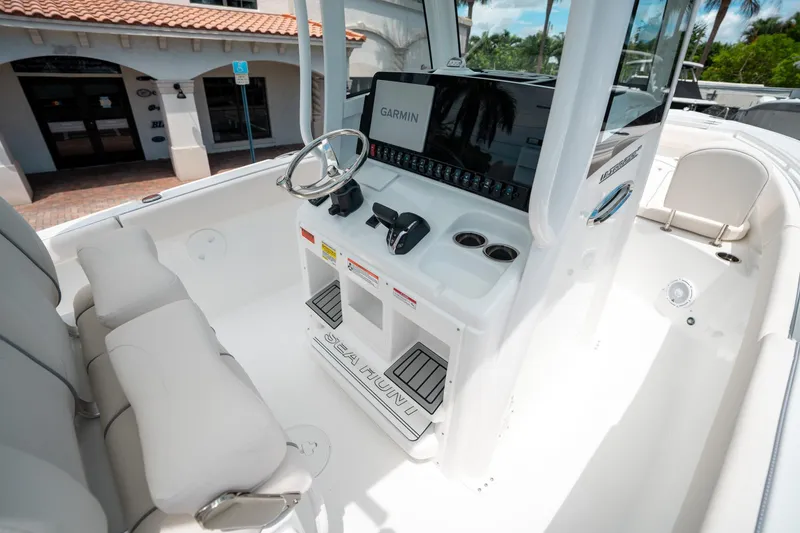 Slide: The Image of 2025 Sea Hunt Ultra 255 SE boat interior with steering console and seating. - 27