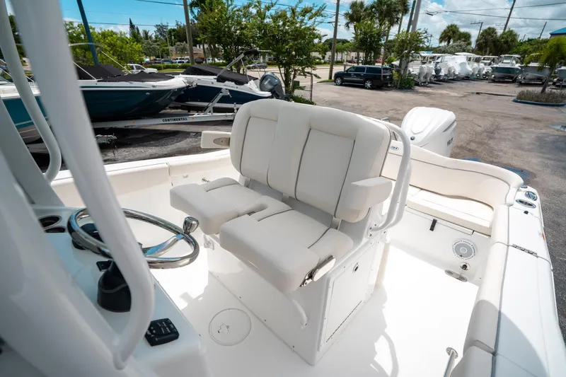 Slide: The Image of 2025 Sea Hunt Ultra 255 SE boat interior with white seating and steering wheel. - 31