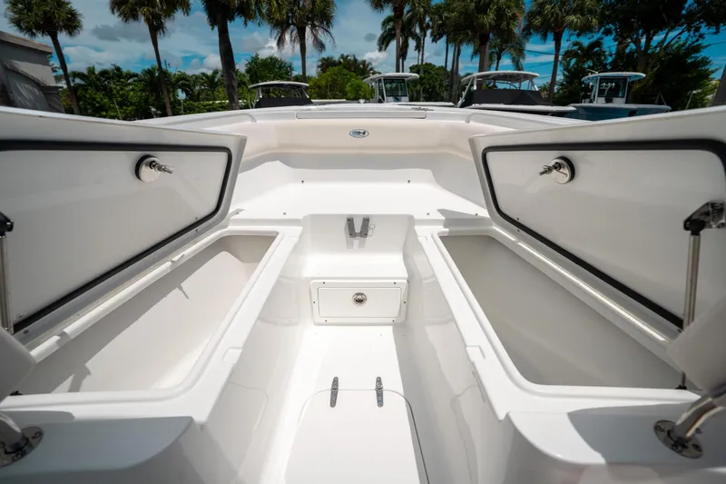 Slide: The Image of 2025 Sea Hunt Ultra 255 SE boat storage compartments open, showcasing spacious interior design. - 41