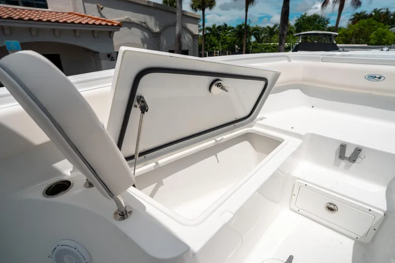 Slide: The Image of 2025 Sea Hunt Ultra 255 SE boat storage compartment open, showcasing spacious interior design. - 42