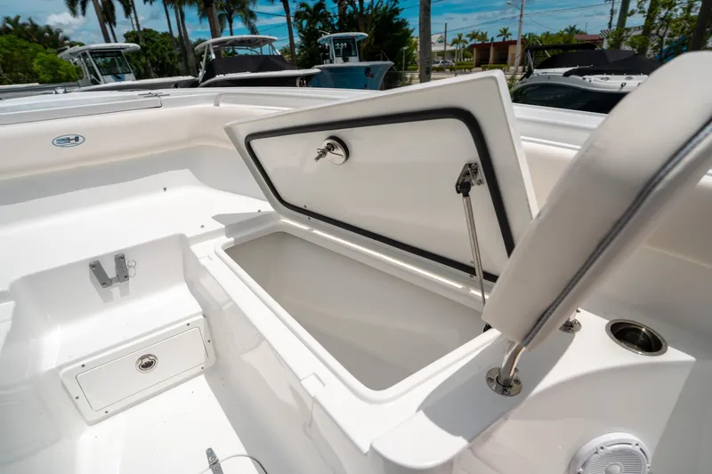 Slide: The Image of 2025 Sea Hunt Ultra 255 SE boat with open storage compartment, showcasing sleek design. - 43
