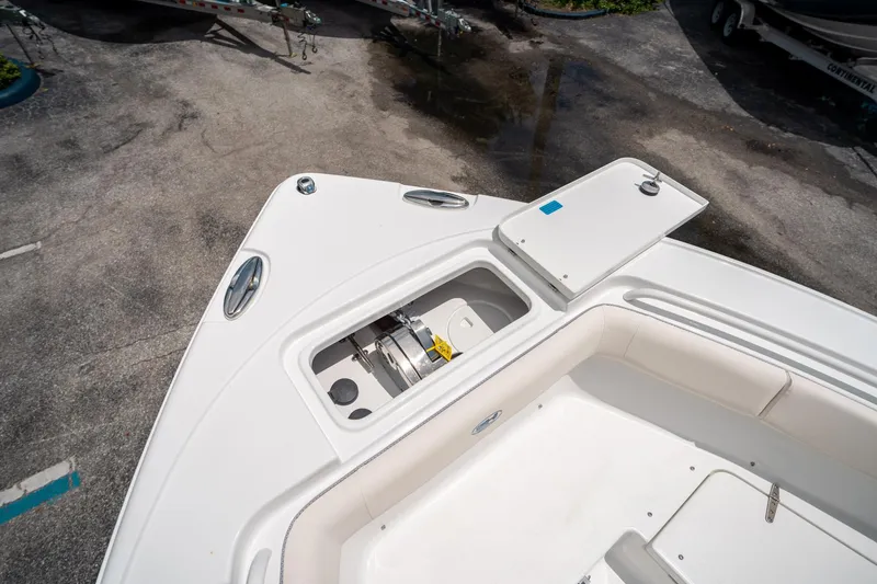 Slide: The Image of 2025 Sea Hunt Ultra 255 SE boat deck with storage compartment open. - 46