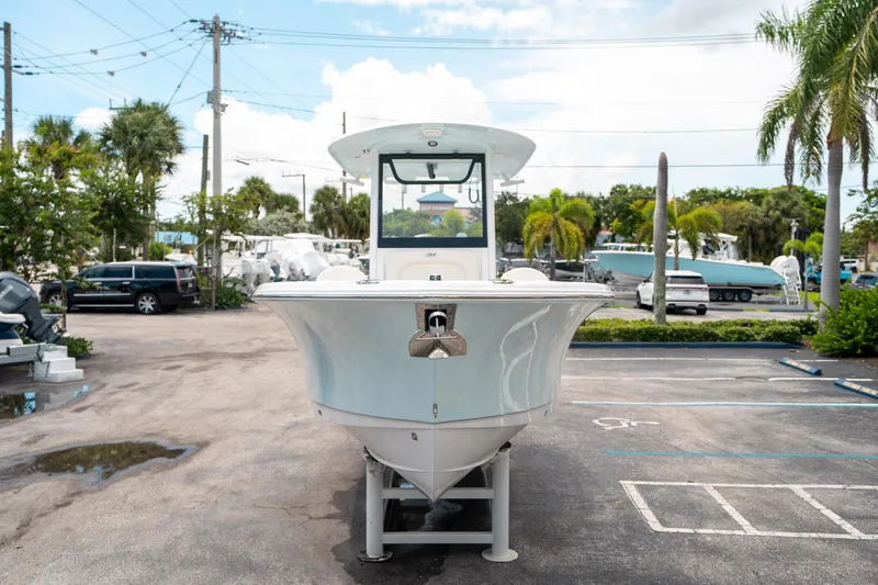 Slide: The Image of 2025 Sea Hunt Ultra 255 SE boat displayed in a parking lot with palm trees. - 7