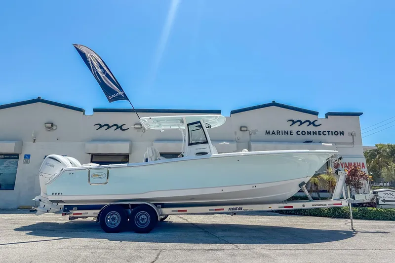 Slide: The Image of 2025 Sea Hunt Ultra 305 SE boat displayed at Marine Connection dealership. - 1