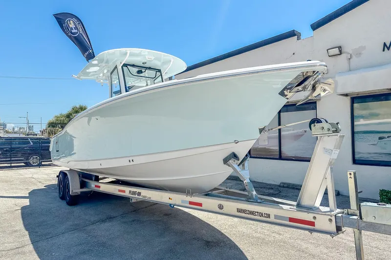 Slide: The Image of 2025 Sea Hunt Ultra 305 SE boat dashboard with Garmin displays and steering wheel. - 4