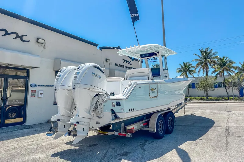 Slide: The Image of 2025 Sea Hunt Ultra 305 SE boat interior with seating and storage, displayed outdoors. - 6